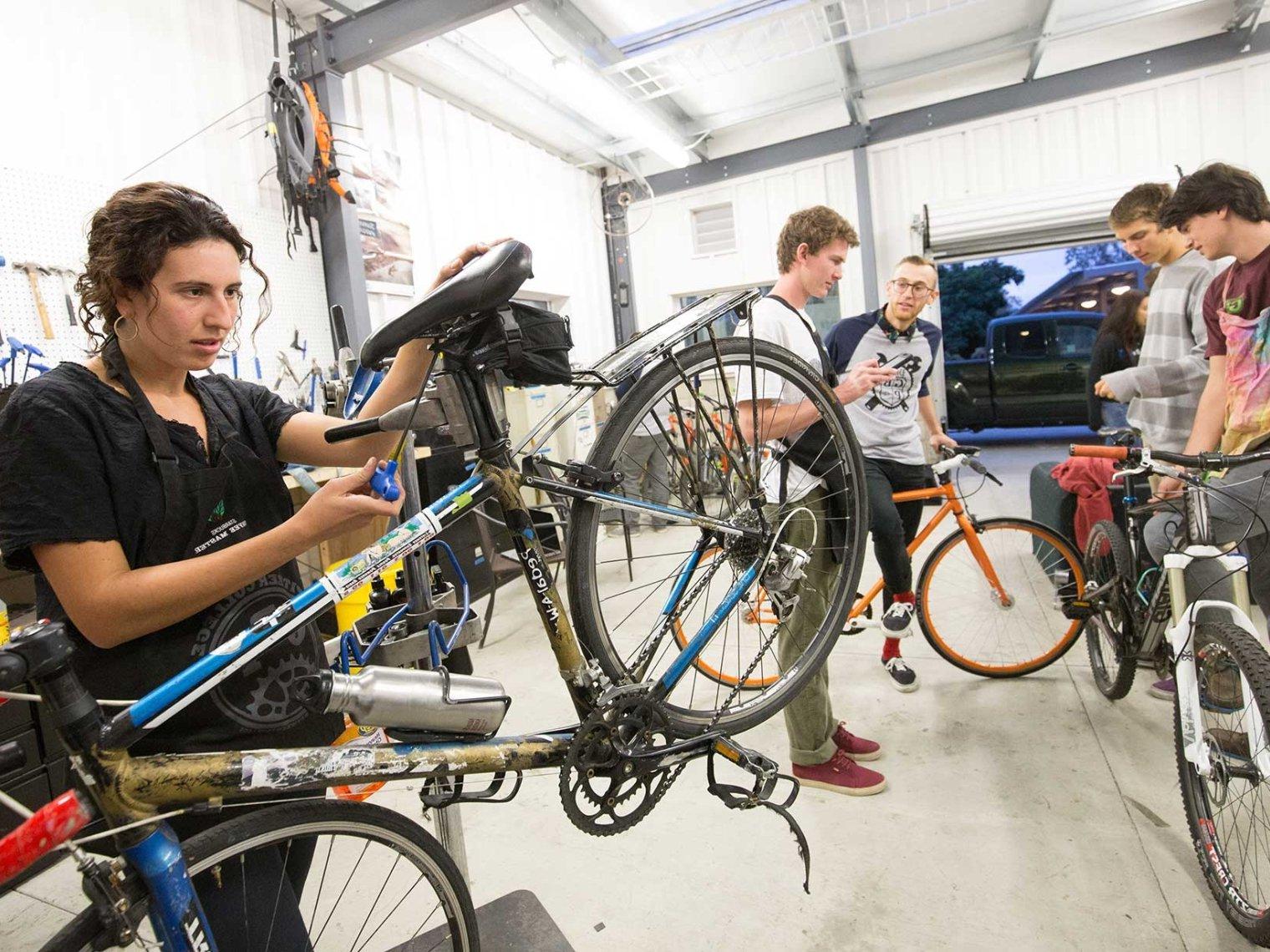 five students work on bikes